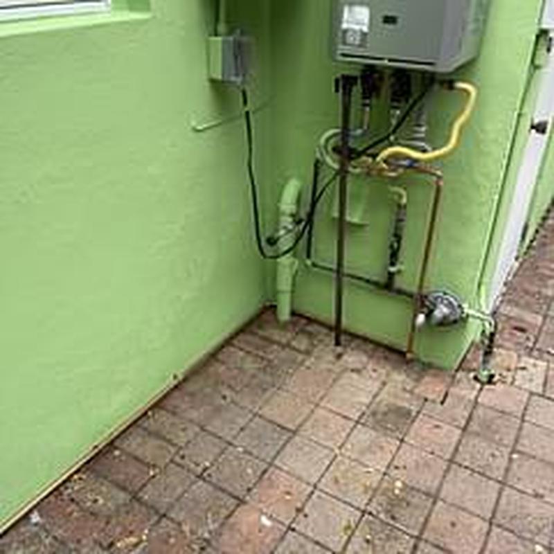 Tankless water heater and copper piping installation outdoors