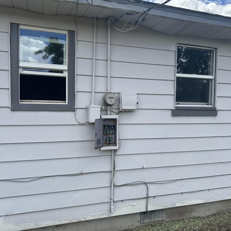 Main service electrical panel with meter on house exterior Main service electrical panel with meter on house exterior