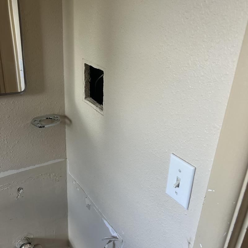 Electrical wall outlet box installation in bathroom wall Electrical wall outlet box installation in bathroom wall