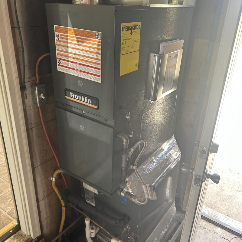 Furnace unit with energy guide label in utility room Furnace unit with energy guide label in utility room