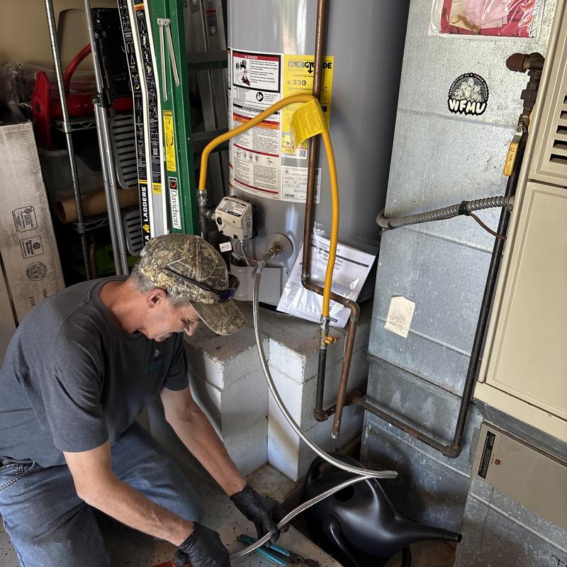 State water heater with technician performing maintenance State water heater with technician performing maintenance