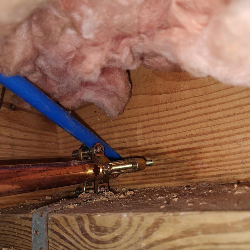 Copper water pipe with blue PEX tubing clamps Copper water pipe with blue PEX tubing clamps
