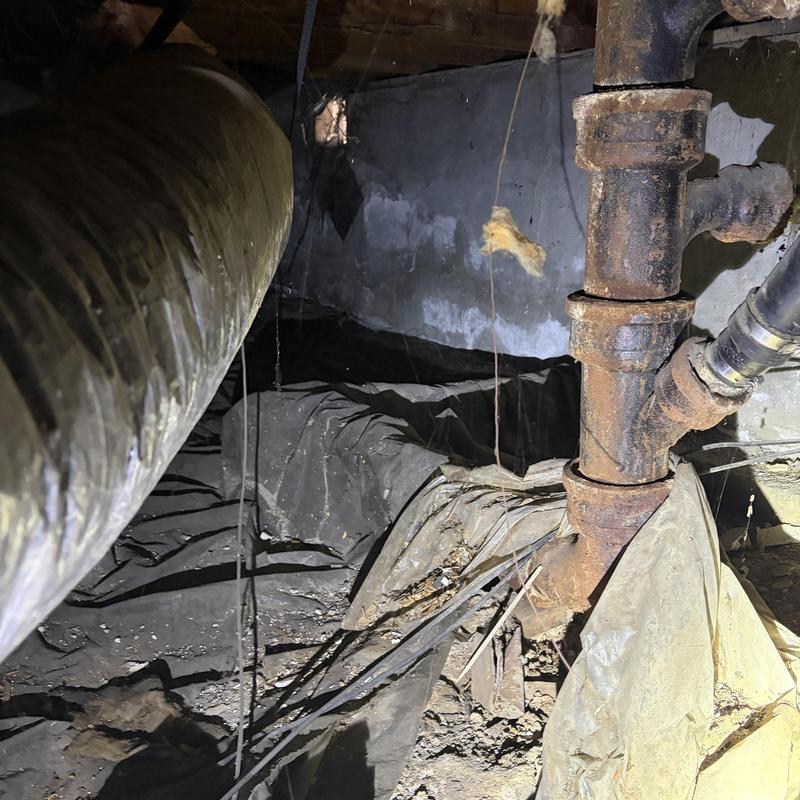 Rusty sewer main pipe in crawl space inspection Rusty sewer main pipe in crawl space inspection