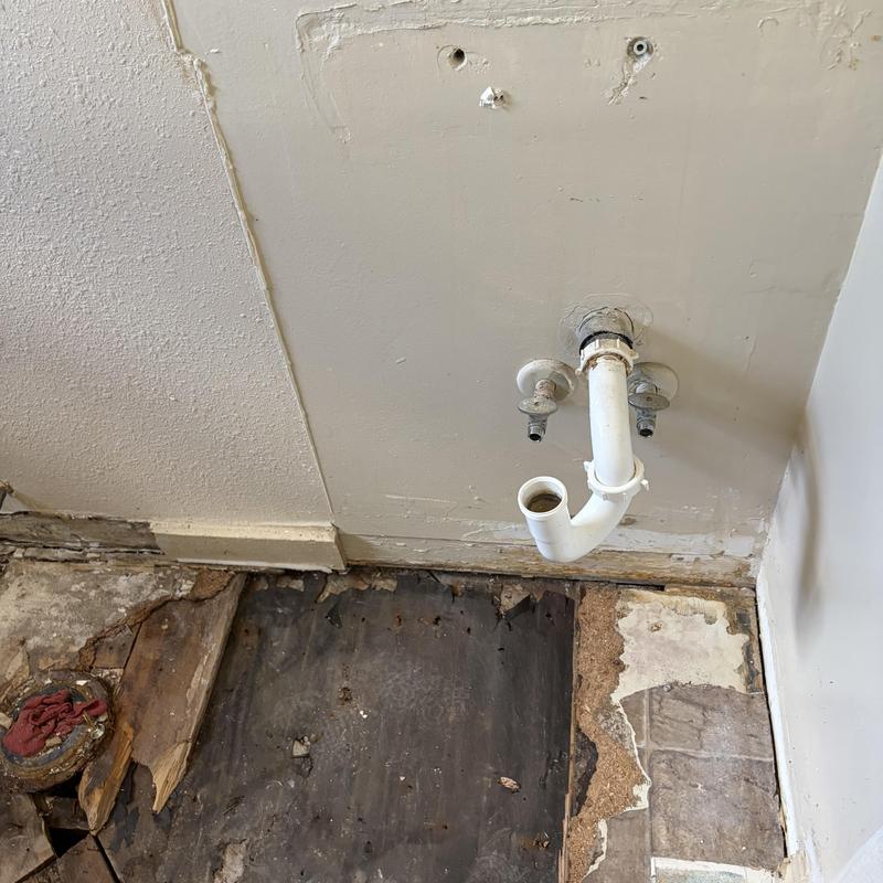 Sink drain pipe and water supply valves exposed for repair Sink drain pipe and water supply valves exposed for repair