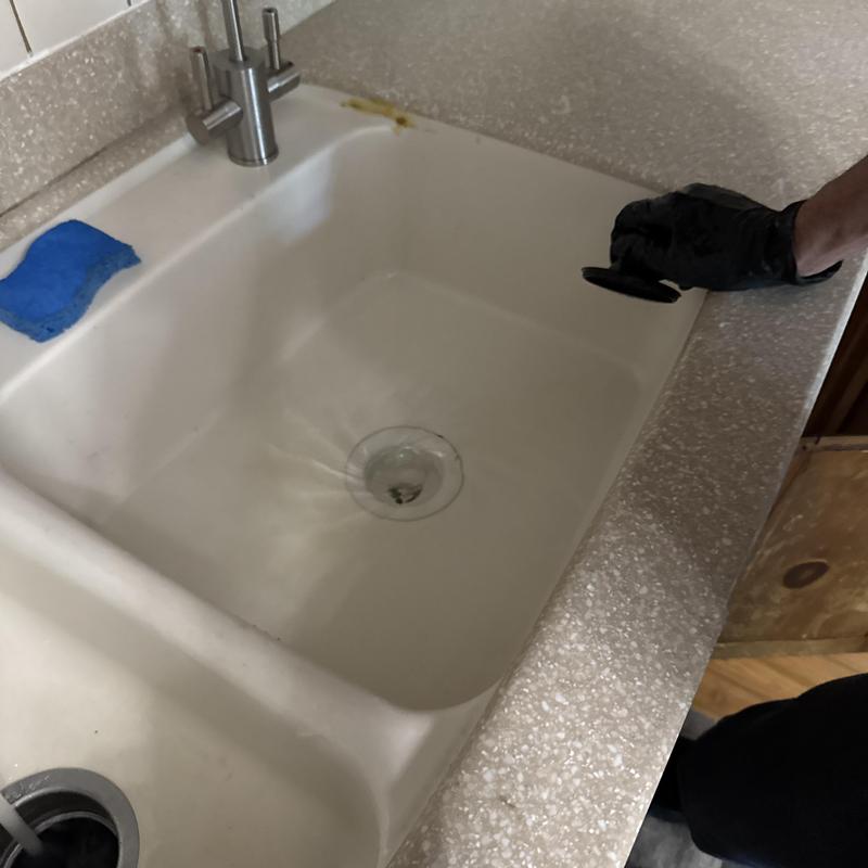Kitchen sink drain with black-gloved hand removal tool