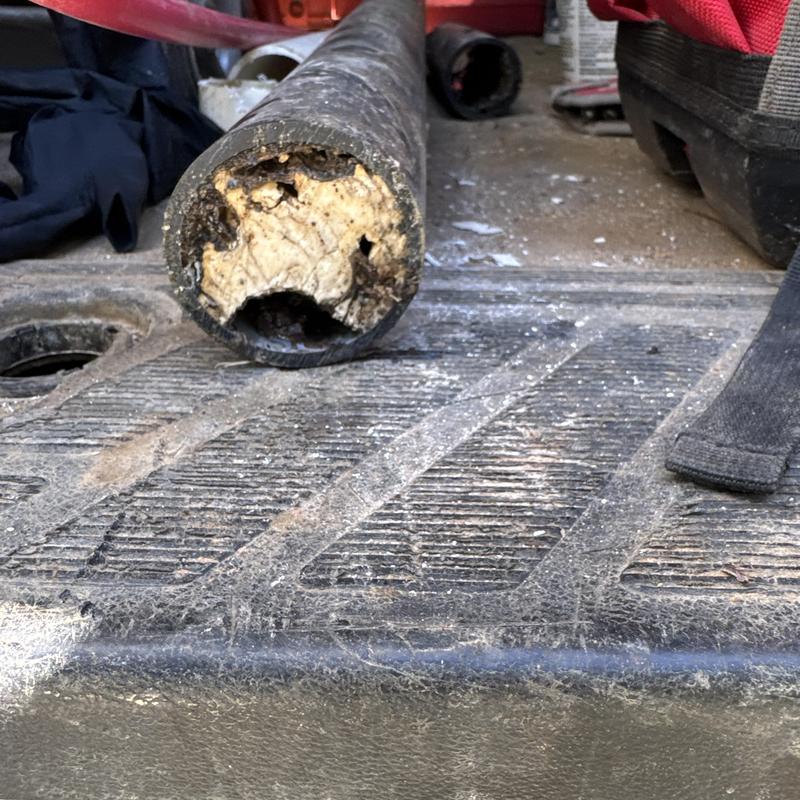 Clogged 2-inch kitchen drain pipe section removed