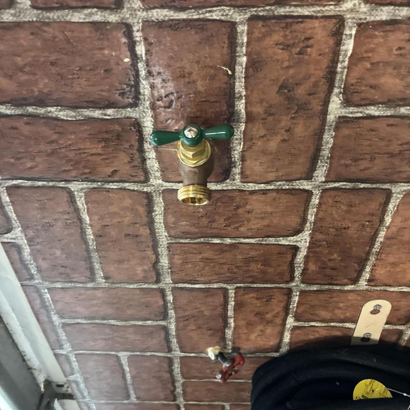 Hose bib valve replacement on brick exterior wall