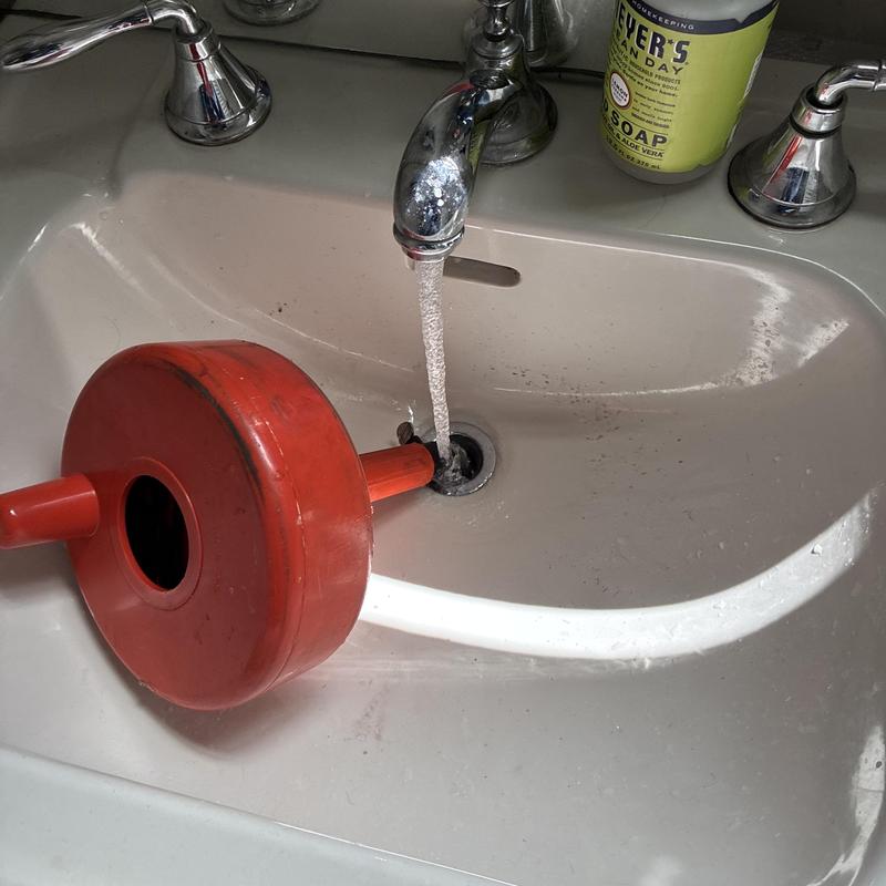 Bathroom sink drain with cleaning machine and running water