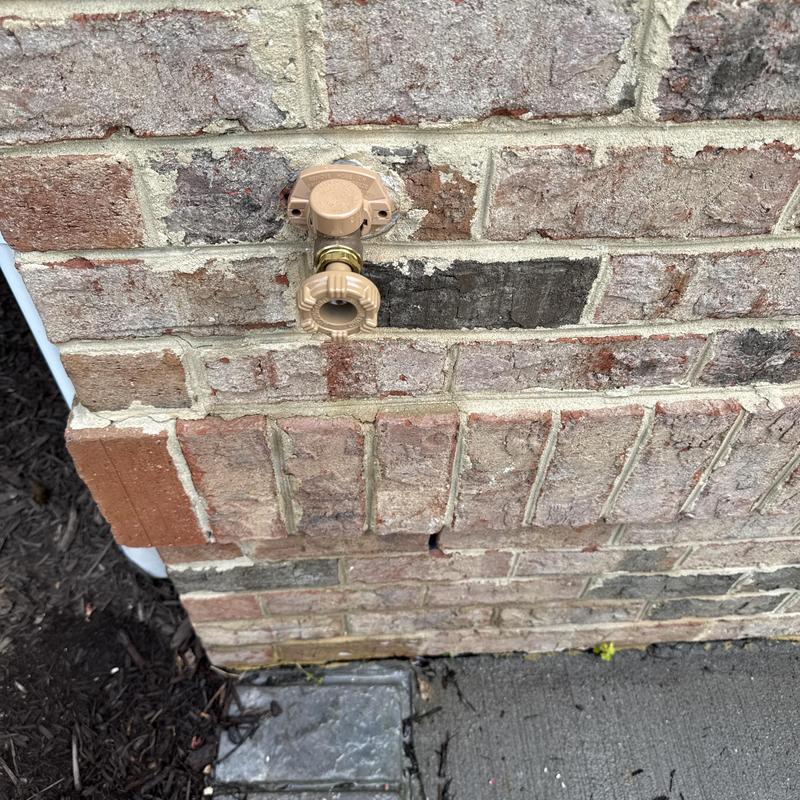 Frost-free hose bib with shutoff valve on brick wall Frost-free hose bib with shutoff valve on brick wall