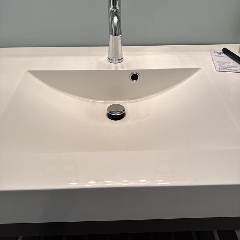 Delta lavatory faucet and sink with chrome drain stopper Delta lavatory faucet and sink with chrome drain stopper