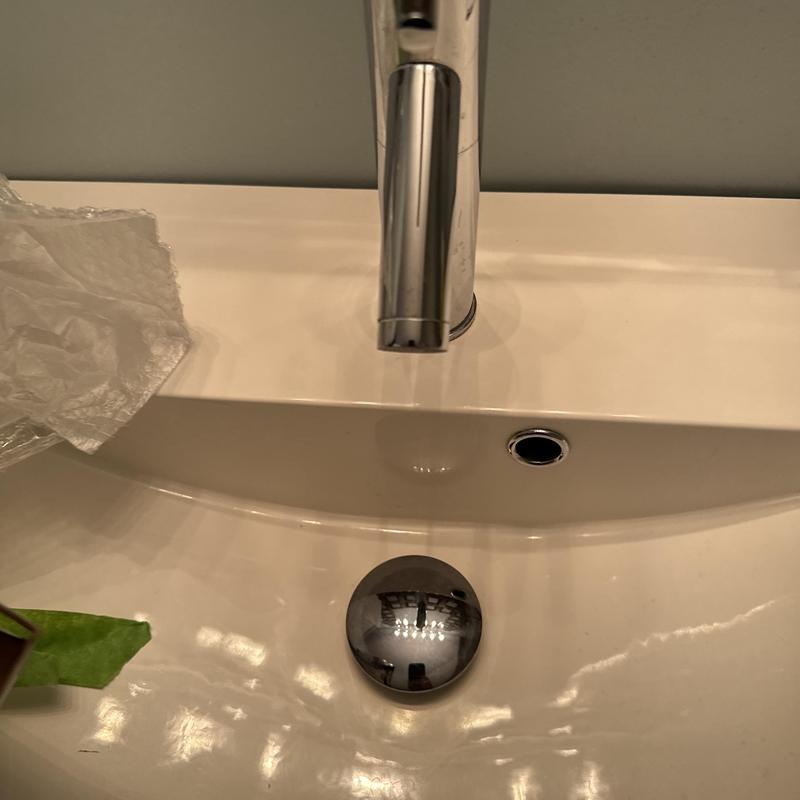 Delta lavatory faucet and sink drain in use Delta lavatory faucet and sink drain in use
