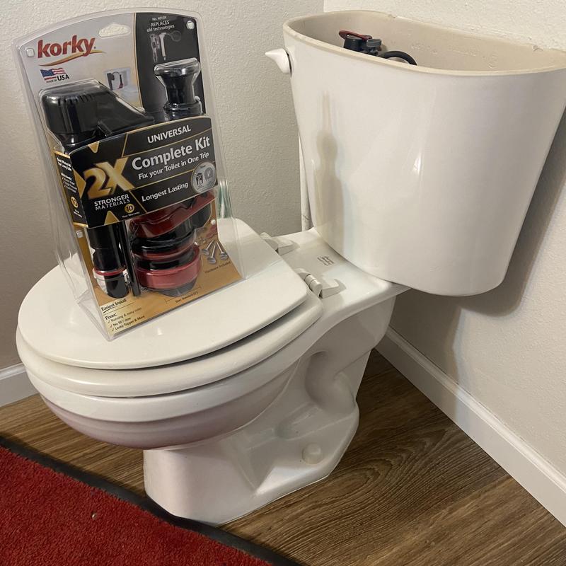 Toilet tank repair kit placed on toilet bowl