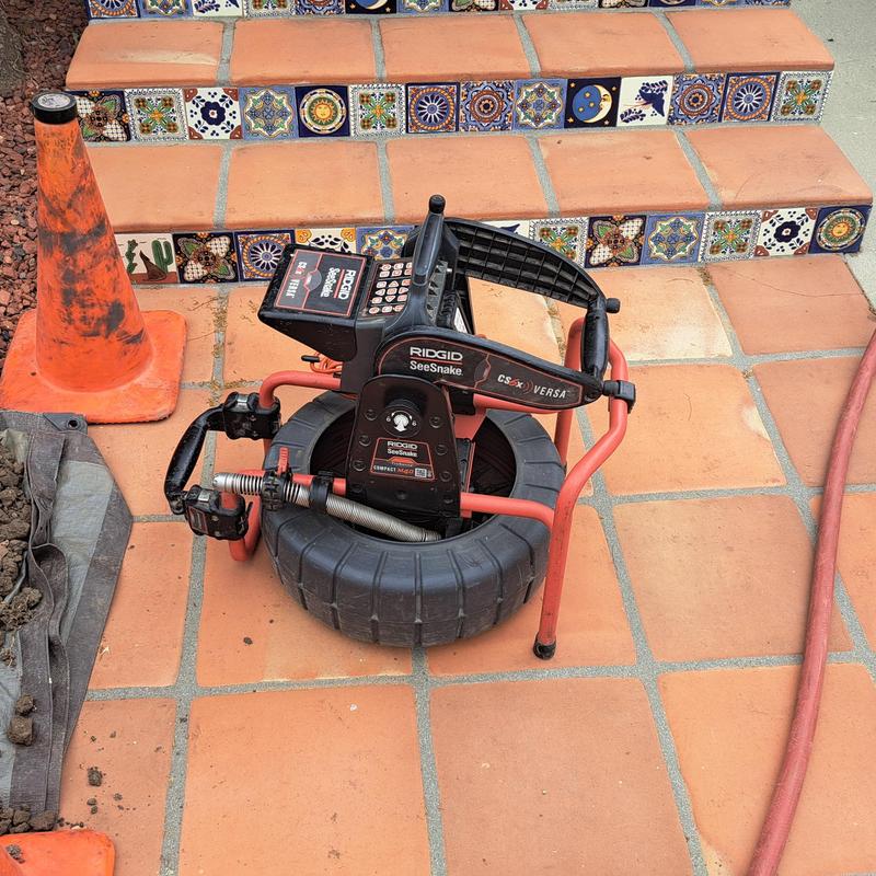 Drain inspection camera system on tiled patio