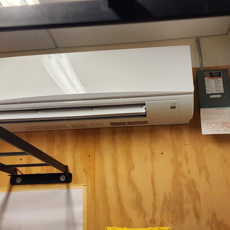 Mitsubishi 24k BTU mini split cooling system on wood wall Mitsubishi 24k BTU mini split cooling system on wood wall