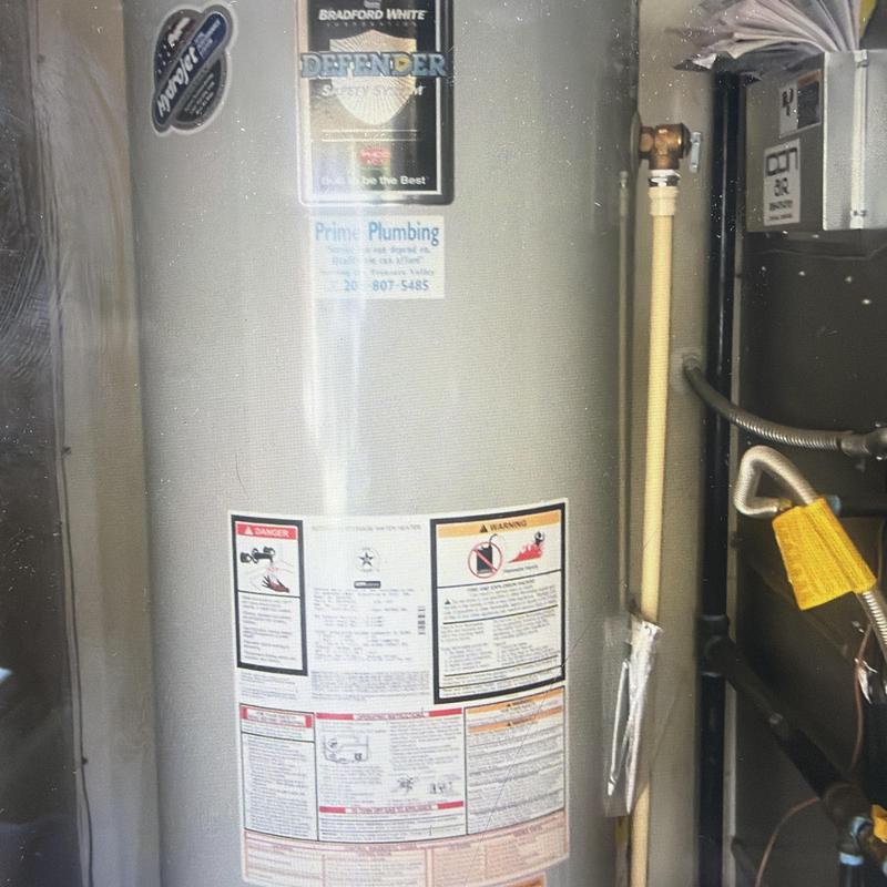 Water heater with safety and warning labels in utility area Water heater with safety and warning labels in utility area