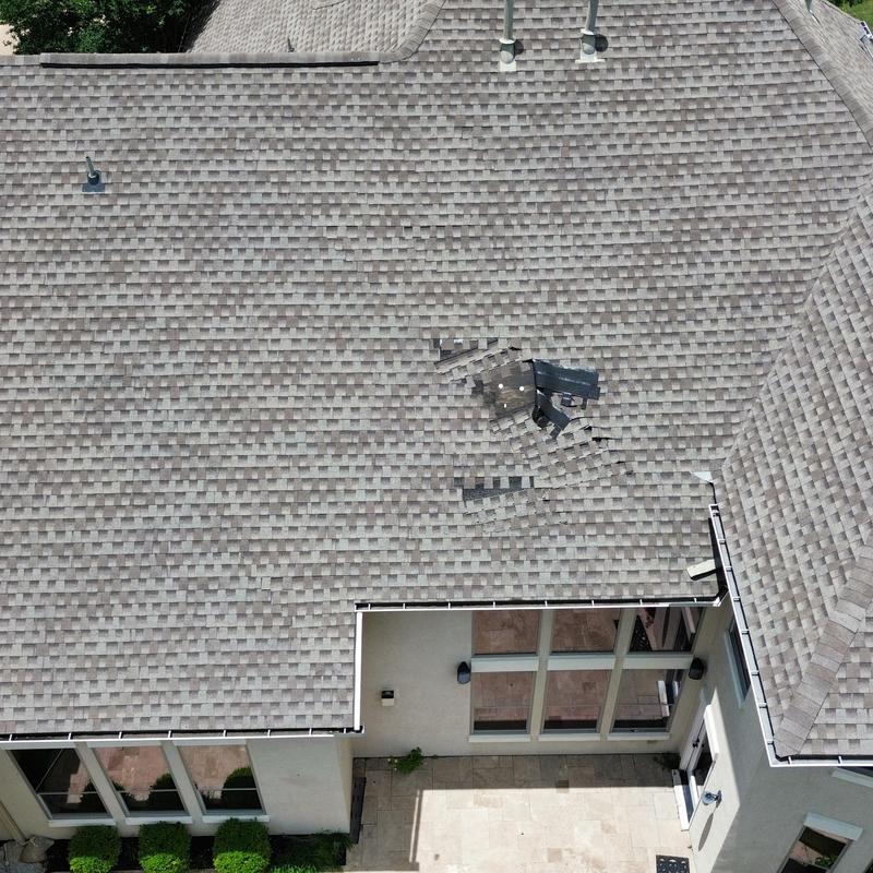 Weather wood shingles roof with wind damage and missing shingles Weather wood shingles roof with wind damage and missing shingles