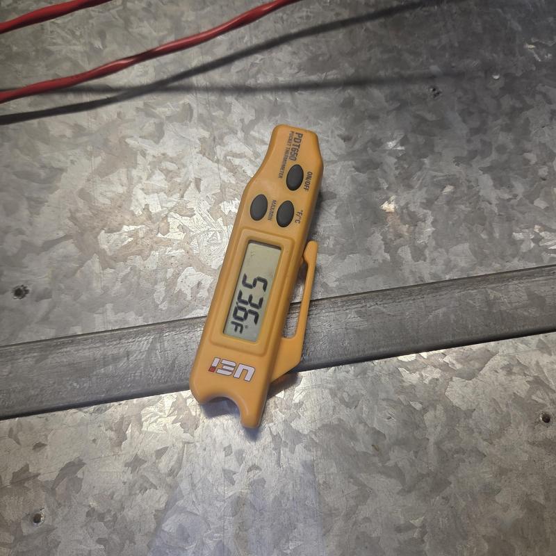 Digital thermometer displaying temperature on HVAC ductwork Digital thermometer displaying temperature on HVAC ductwork