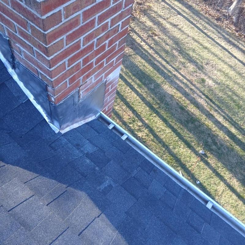 Roof shingles and brick chimney flashing installation Roof shingles and brick chimney flashing installation