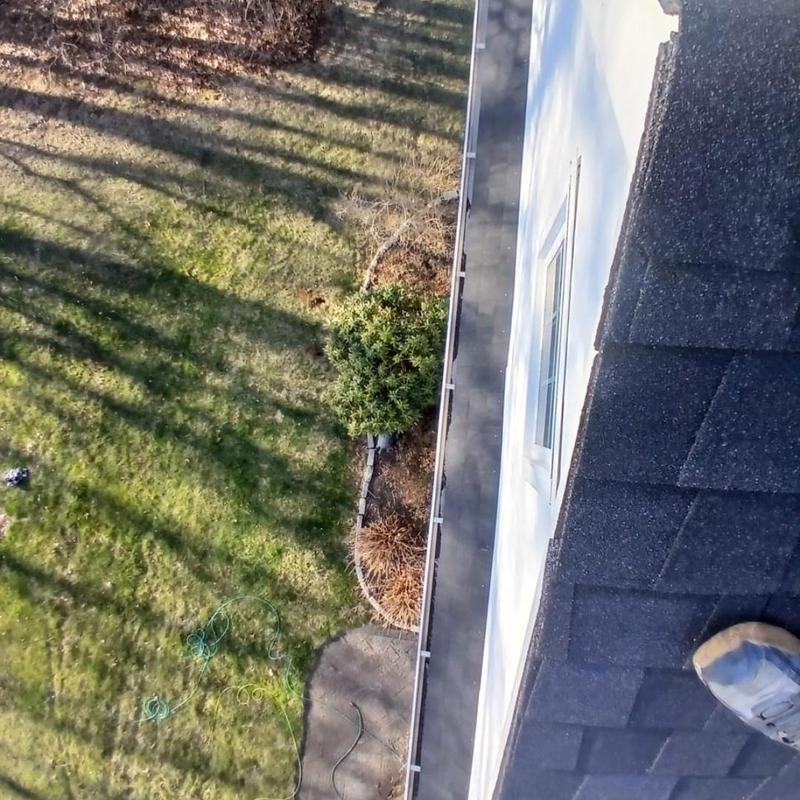 Asphalt shingle roof edge and gutter installation view Asphalt shingle roof edge and gutter installation view