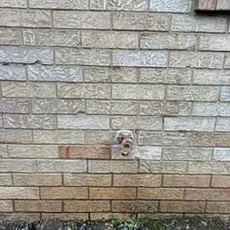Hose bib installed on exterior brick wall Hose bib installed on exterior brick wall