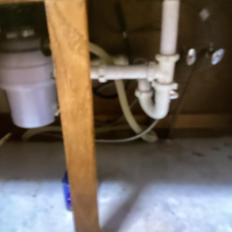 Garbage disposal and under sink piping in kitchen cabinet Garbage disposal and under sink piping in kitchen cabinet