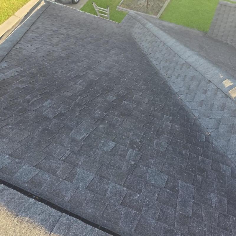 Aging asphalt shingle roof with weathering signs