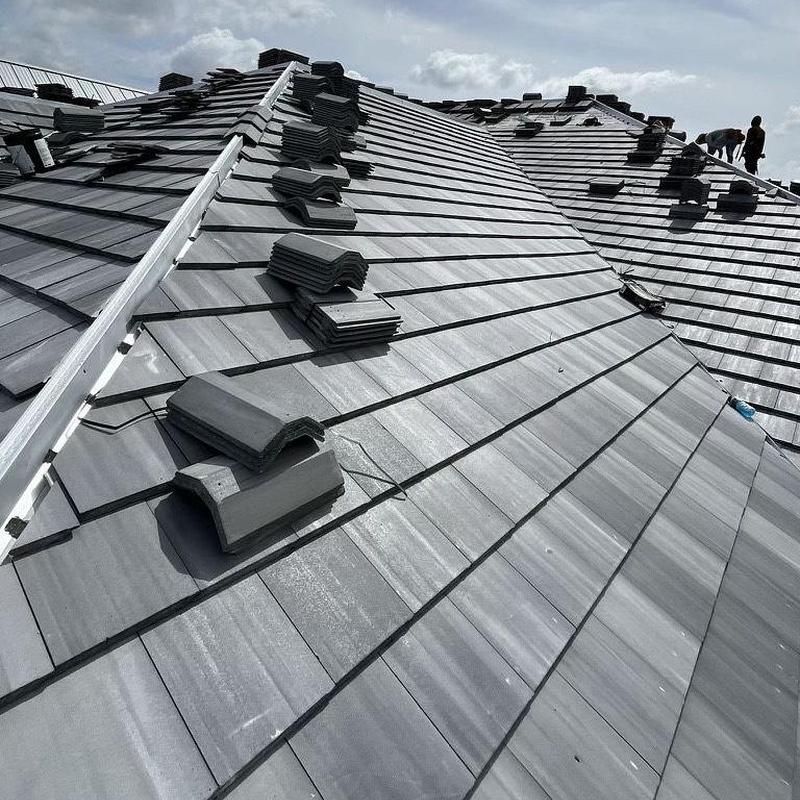 Concrete tile roof installation with metal dormers Concrete tile roof installation with metal dormers