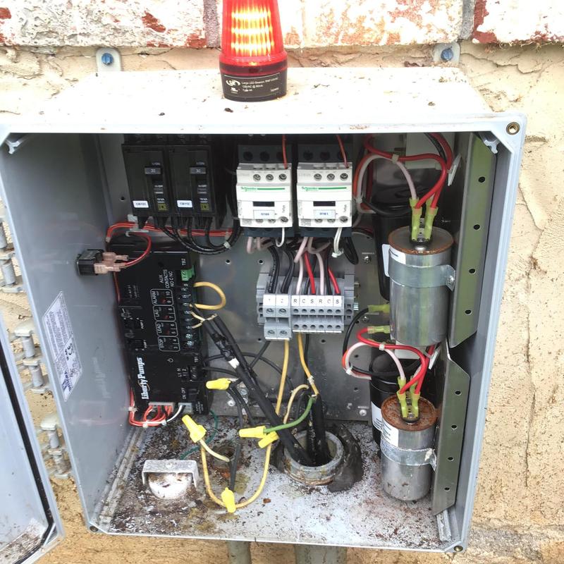 Pump control panel with capacitors and wiring in enclosure Pump control panel with capacitors and wiring in enclosure