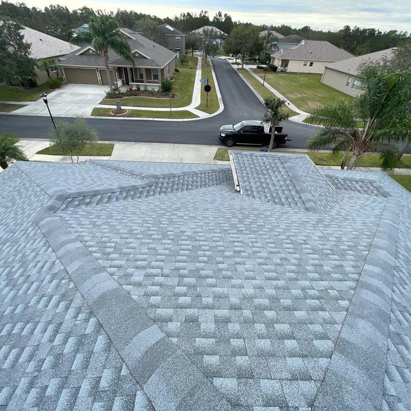 Asphalt shingle roof with new ridge cap installation Asphalt shingle roof with new ridge cap installation