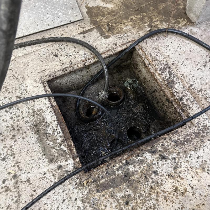 Sanitary drain cleaning with cables in floor pit Sanitary drain cleaning with cables in floor pit
