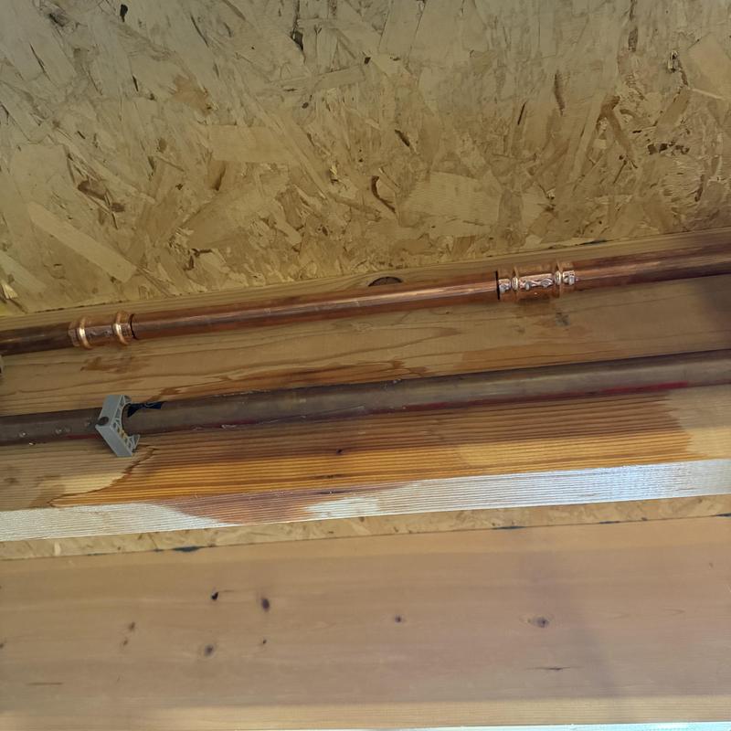 Copper water pipes with visible wood water damage Copper water pipes with visible wood water damage