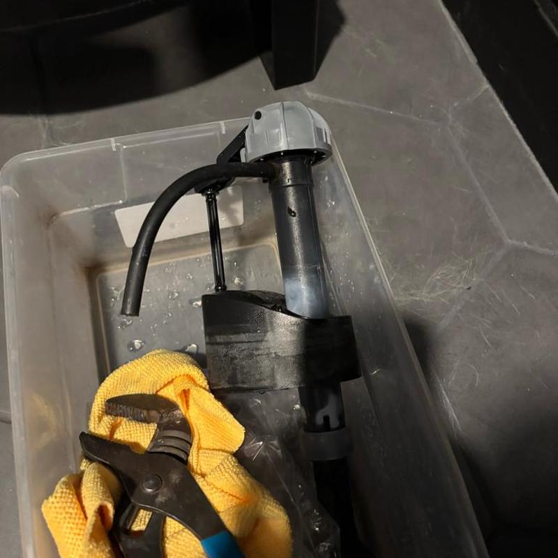 Toilet fill valve with wrench and cloth in container
