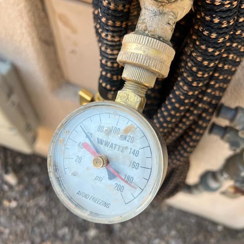 Pressure gauge on water service line showing PSI
