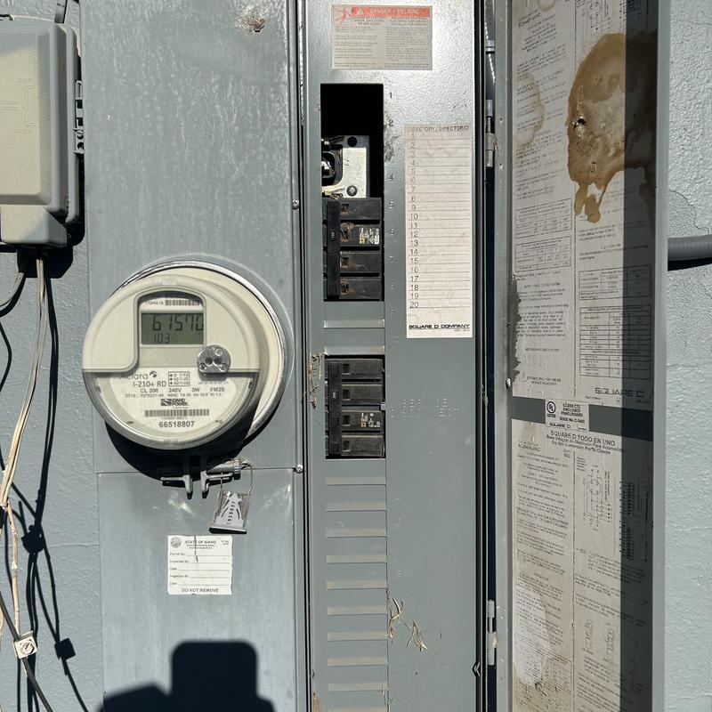 Electrical meter and circuit breaker panel outdoors Electrical meter and circuit breaker panel outdoors