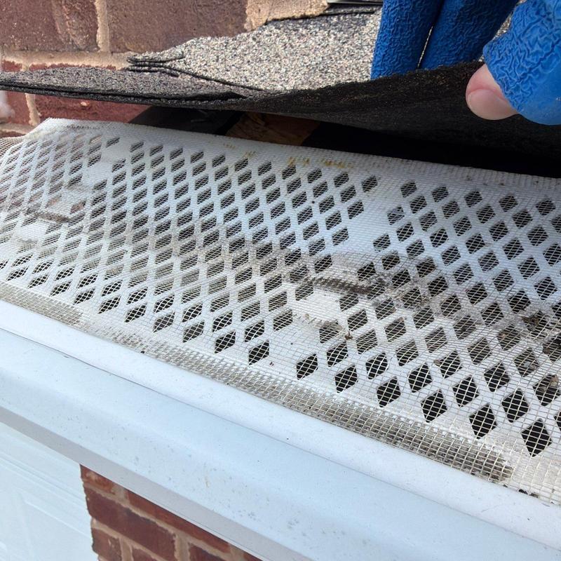 Roof shingles lifted to inspect roof ventilation vents