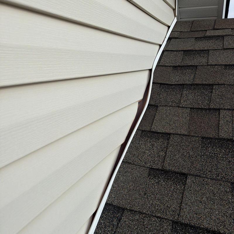 Valley flashing between siding and asphalt roof shingles