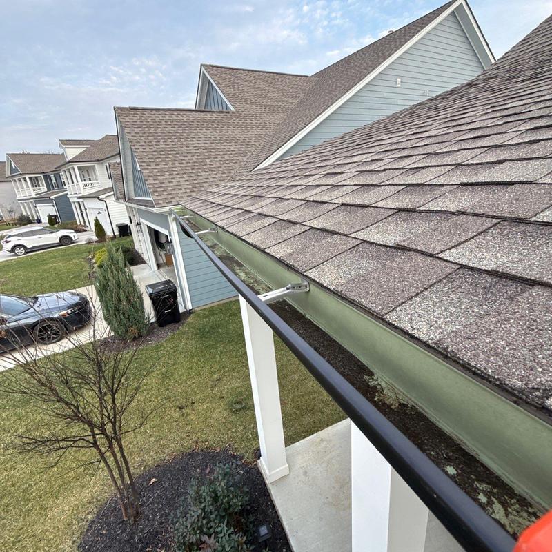 Asphalt shingle roof and gutter system inspection in neighborhood