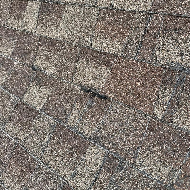 Asphalt shingle roof with hail damage and wear