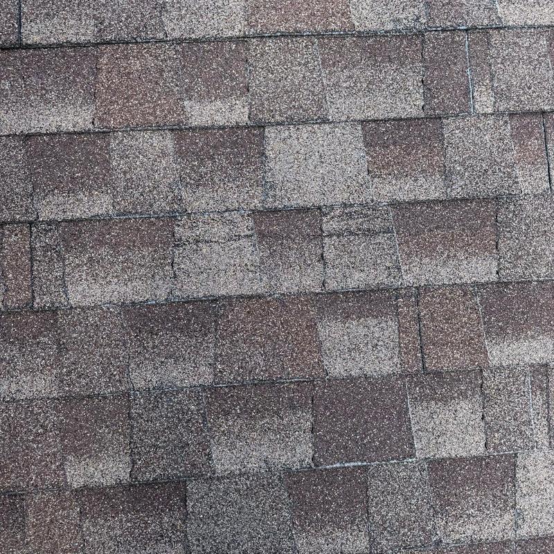 Asphalt shingles with hail damage spotting