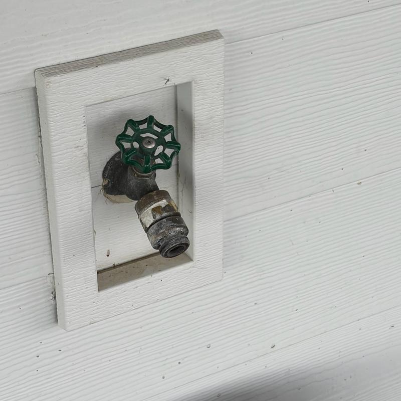 Outdoor water spigot with green handle and seal replacement