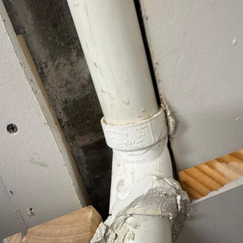 Sump pump discharge pipe with replaced fitting