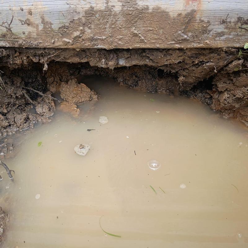 Water meter leak flooding soil hole outdoors Water meter leak flooding soil hole outdoors