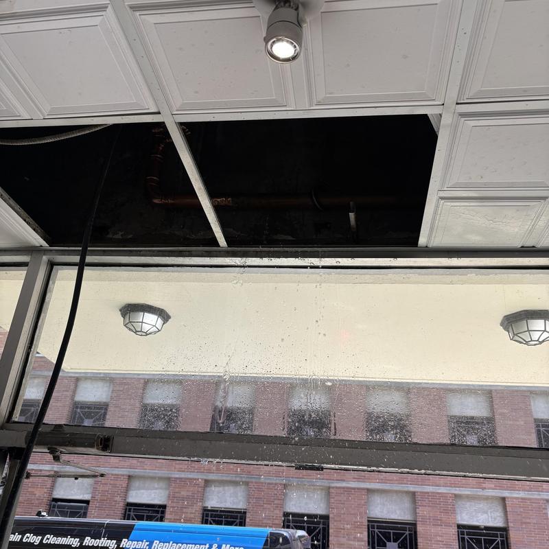 Main water line pipe visible above ceiling tiles Main water line pipe visible above ceiling tiles