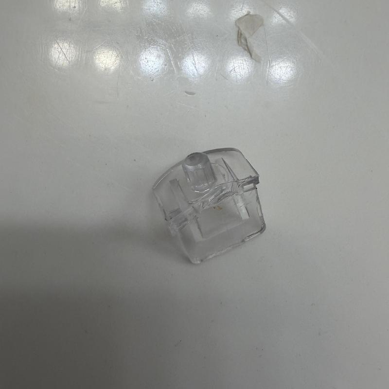 Tub stopper pop-up assembly replacement part on white surface
