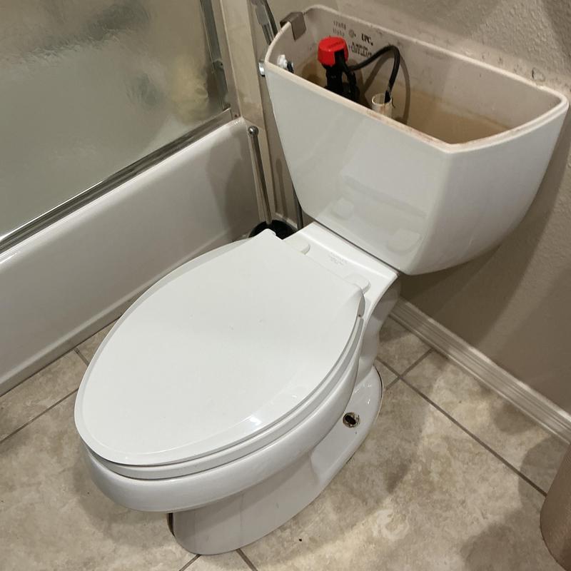 Toilet tank and bowl with open tank lid