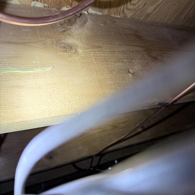 Icemaker water line installation on wooden beam