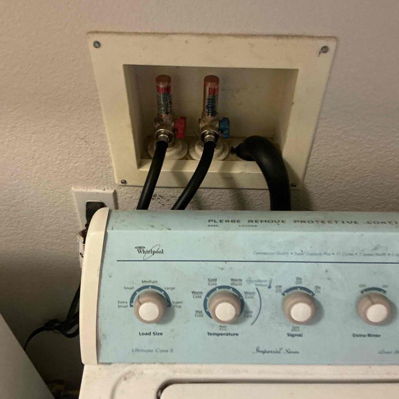 Washing machine hoses connected to water valves