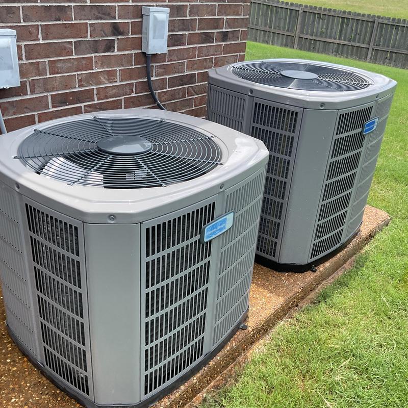 Condenser units air conditioner maintenance near brick wall Condenser units air conditioner maintenance near brick wall