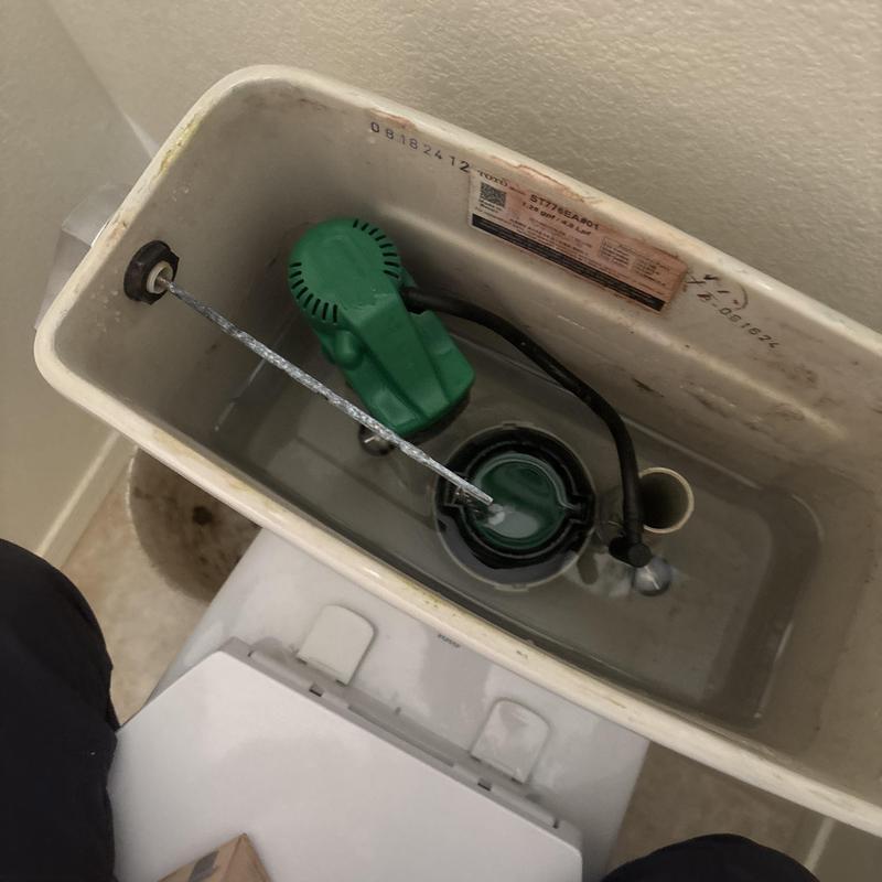 Toilet tank fill valve and flush mechanism interior view