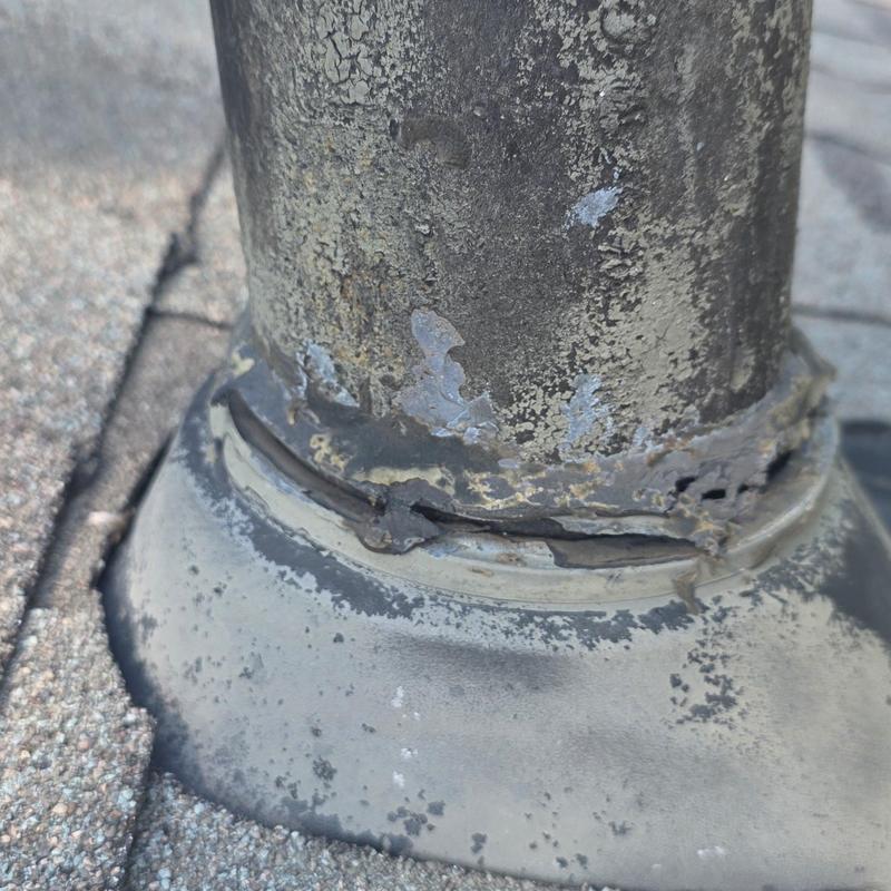 Roof pipe flashing with hail damage and cracking sealant